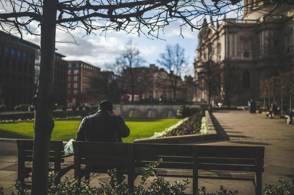Man sitting on a park bench.